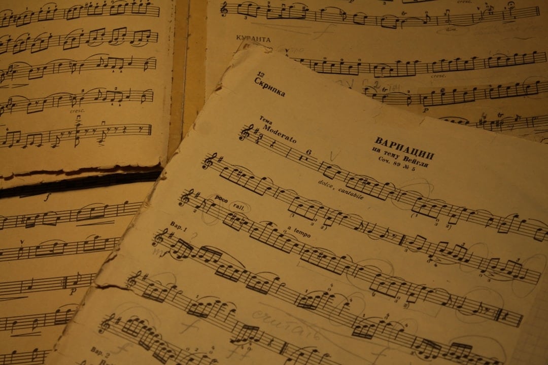 Old sheet music with handwritten musical notations and instructions.